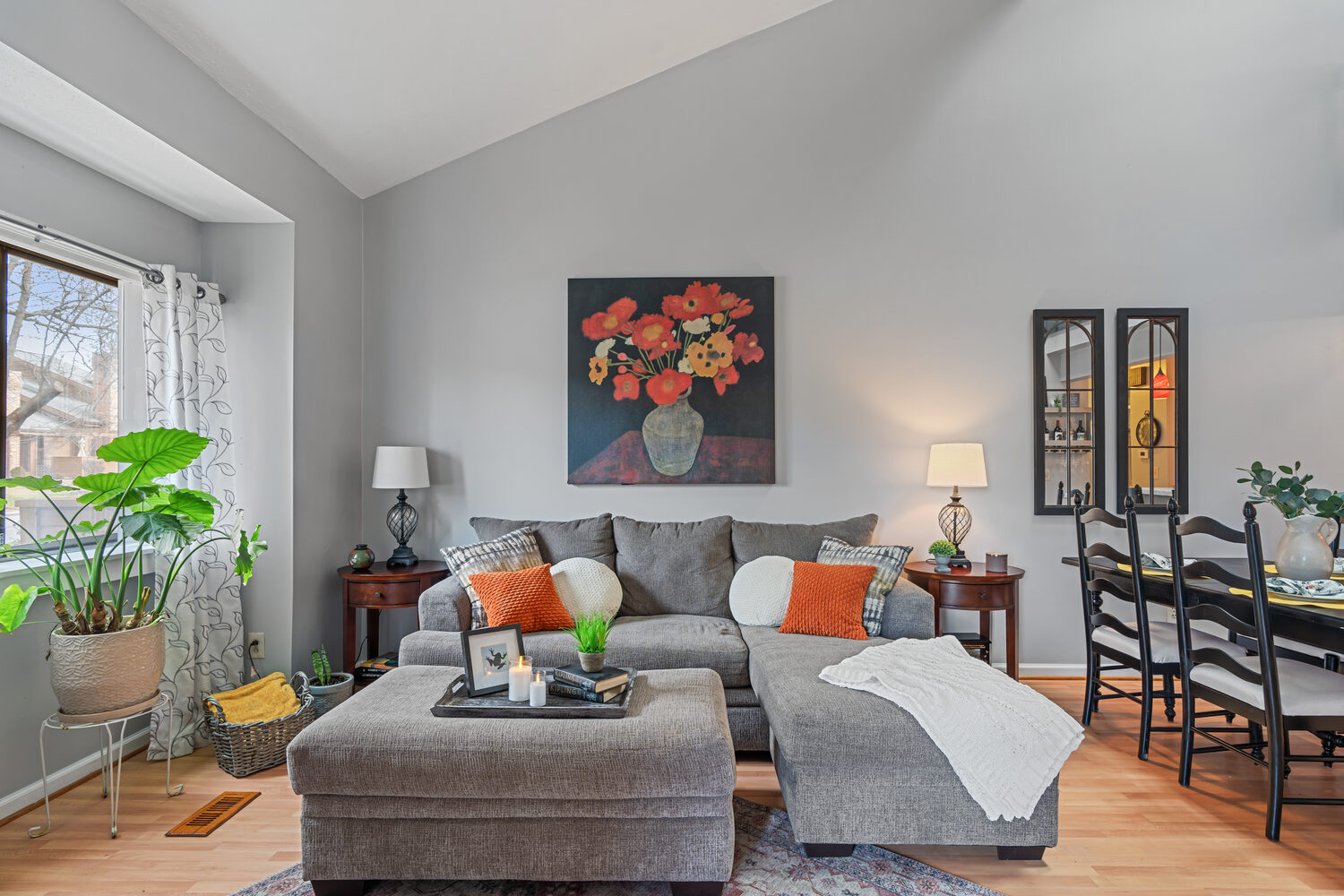Sunlit living room with sectional and gallery art