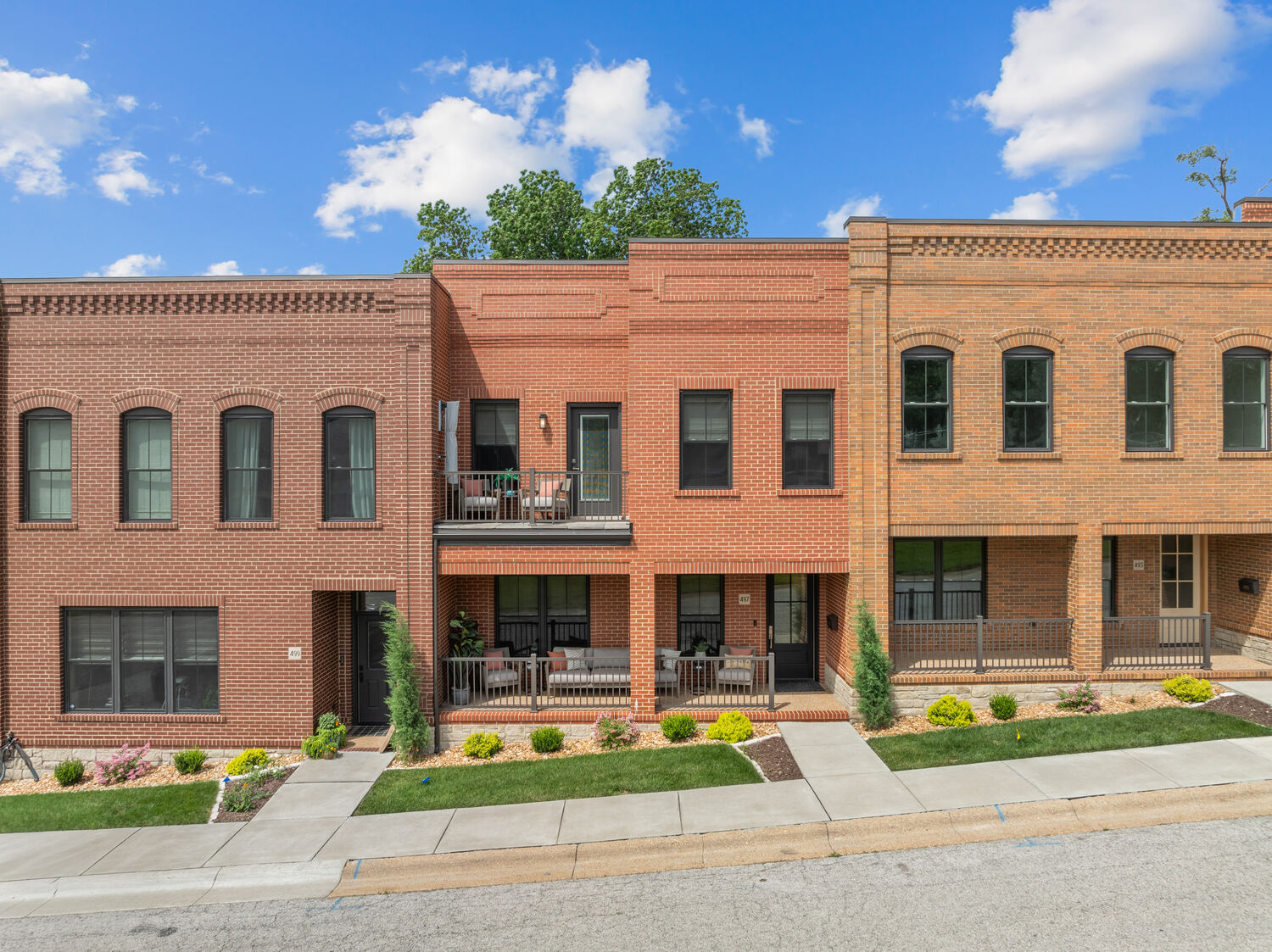 Red-brick townhome with balcony on a downtown Washington street