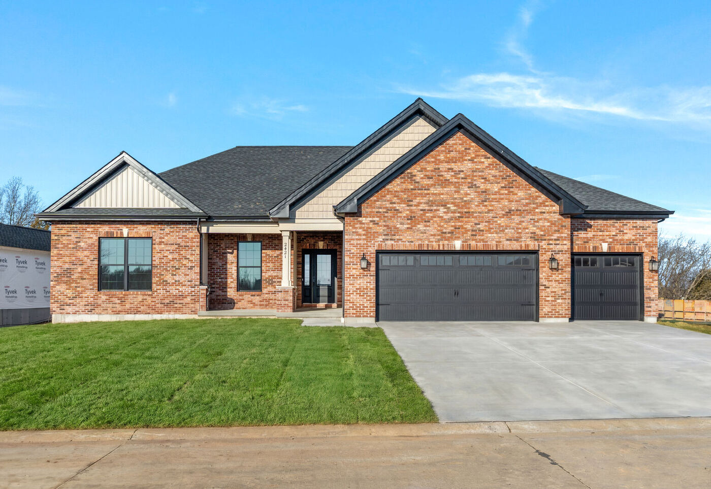Brick ranch home with stone accents and a three-car garage