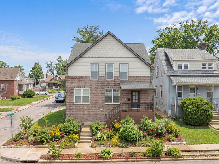 Two-story brick home with landscaped corner lot in Maplewood